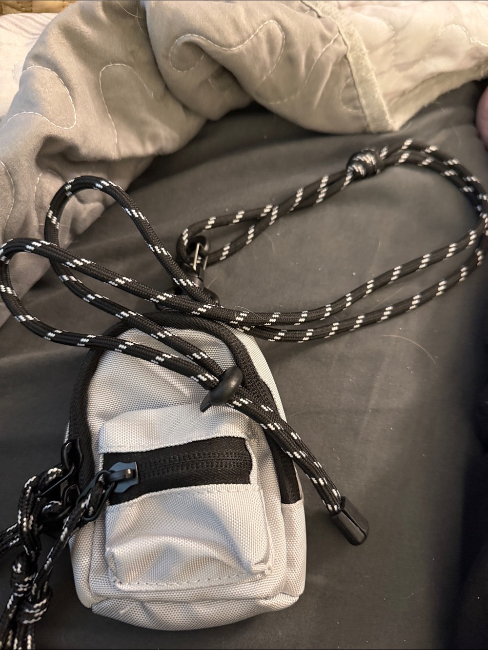 Compact Gray Crossbody Pouch with Black Rope Strap